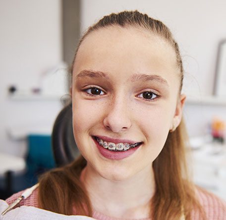 portrait-of-smiling-teenage-girl-with-braces
